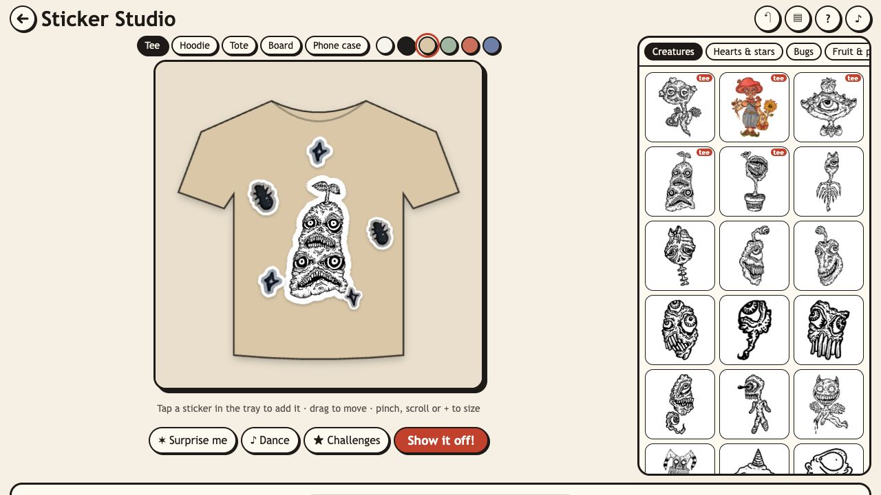 Sticker Studio: a tan tee with a creature sticker in the middle and small motifs around it, next to the sticker tray