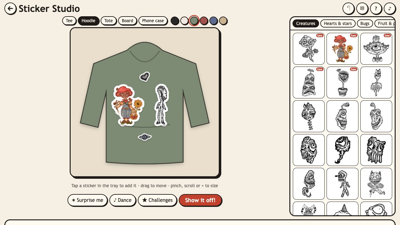 Sticker Studio: a green hoodie with two creature stickers and small motifs